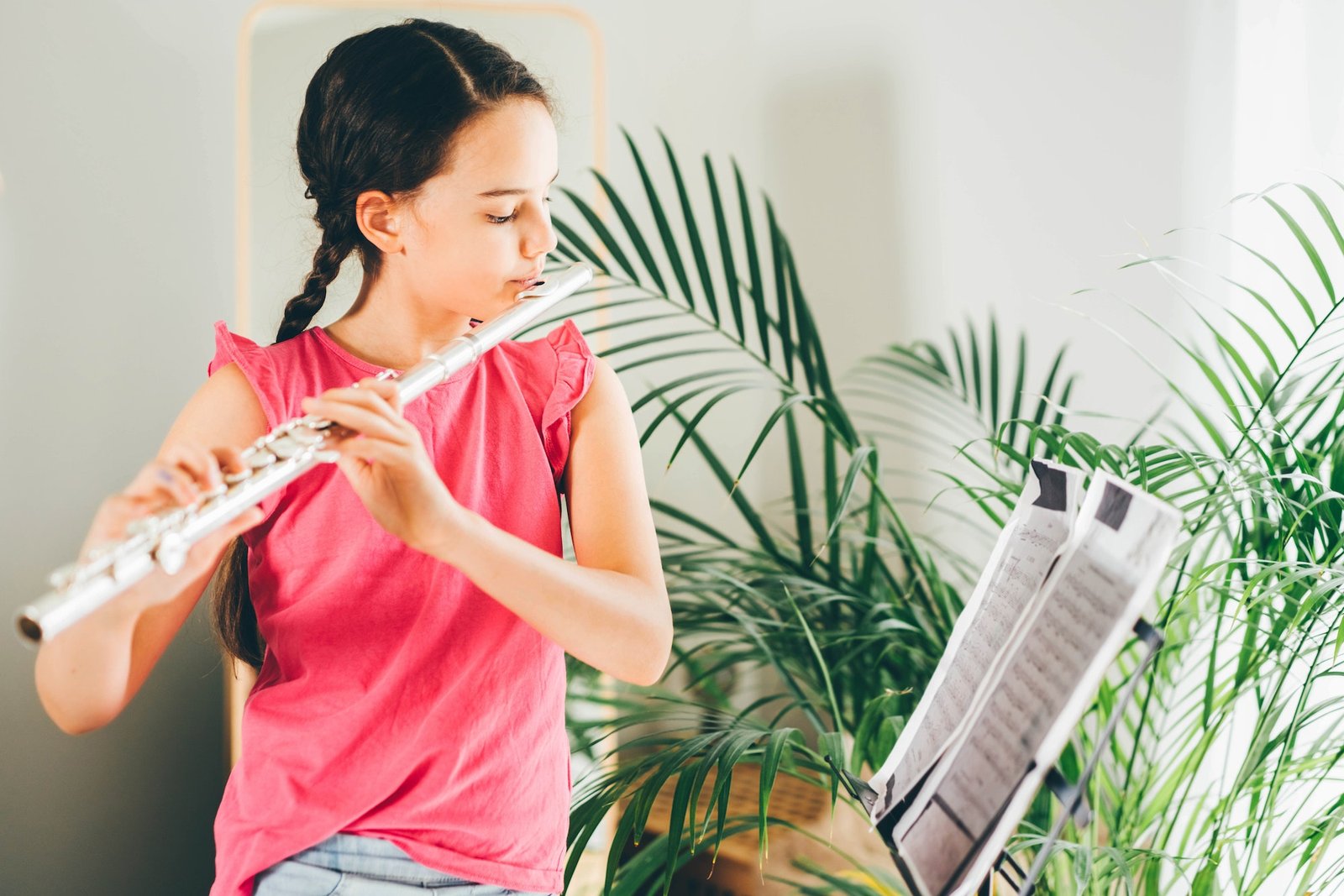 Girl playing the flute at home.