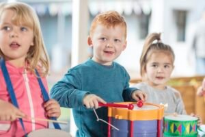 Young children playing with musical instruments